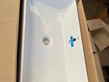 a white sink sitting on top of a cardboard box