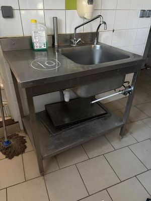 a kitchen with a sink and a stove in it