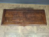 a wooden table with a drawer on top of it