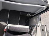 a seat in the back of a bus with a monitor on it