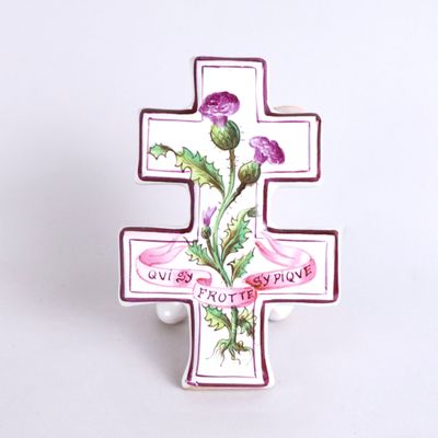 a cross with a flower on it on a white background