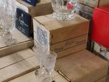 boxes of empty wine glasses on a table in a store