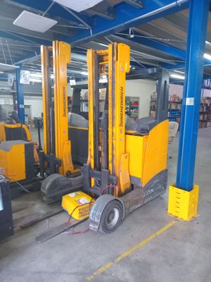 a forklift truck that is parked inside of a warehouse