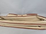 the inside of a tan and brown purse with a brown handle