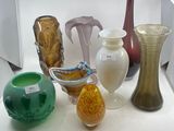 many vases that are sitting on a white table