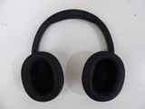 a pair of black headphones sitting on top of a table