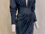 an image of a mannequin wearing a black dress with long sleeves