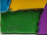 a close up of a colorful cake with icing on it