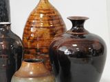 three vases sitting next to each other on a white surface