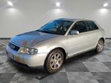 an image of a dirty silver car in a garage