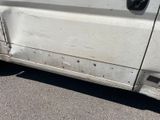 a white van that has been vandalized and is parked in a parking lot