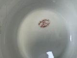 a close up of a white bowl with a red label