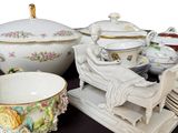 many different types of porcelain dishes and bowls on a table