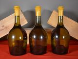three bottles of wine sitting next to each other on a table
