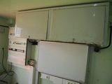 a refrigerator and freezer in a room with green walls
