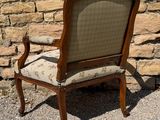 a chair that is sitting in front of a brick wall