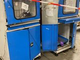 two blue and white machines in a warehouse