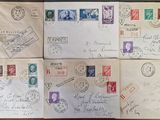 several envelopes with stamps and stamps on them sitting on a table