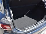 a car with its trunk open on the side of the road
