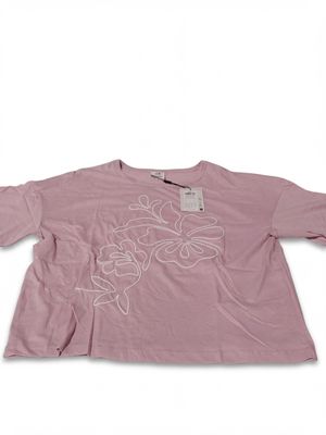 the shirt is pink with white flowers on it