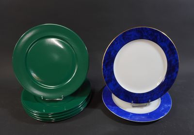 two plates with blue and green rims are sitting on a table