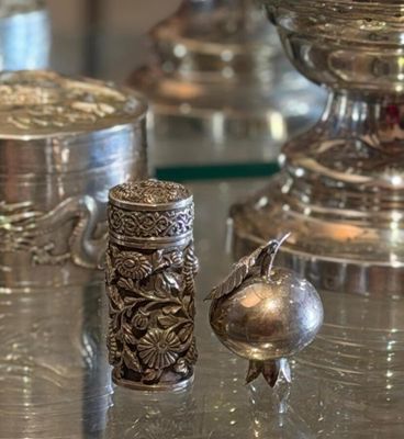 many silver objects on a glass table in a room
