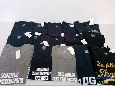 a lot of t - shirts that are on a table