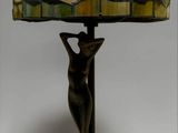 lamp with a bronze base and a stained glass shade on top