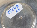 a silver plate with a blue sticker on it