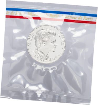 a silver coin in a plastic bag with a red, white and blue stripe