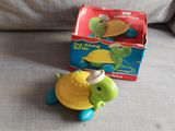 a toy turtle that is sitting next to a box of toys