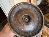 a person holding a metal bowl in their hand