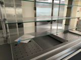 a glass display case in the middle of a kitchen