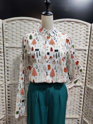 blouse and pants with a pattern of cats and trees on them