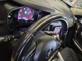 a steering wheel and dashboard of a car in a showroom