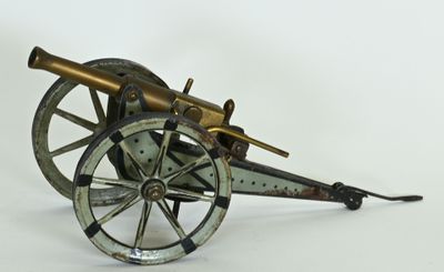 an old model of a cannon sitting on top of a white surface