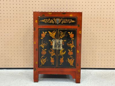a small cabinet with a floral design on it