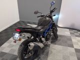 a motorcycle that is parked in a room with a checkered floor