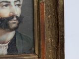 portrait of a man with a turban and a beard in a gold frame