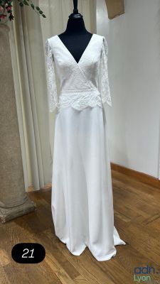 a white dress on a mannequin stand in a room