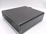 an image of a black computer sitting on top of a white surface