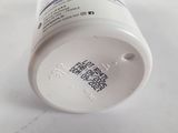 a bottle of pills sitting on a white surface