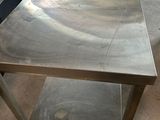 a stainless steel table in a kitchen with a bowl on it