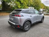the rear end of a silver suv parked in a parking lot