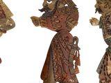 three wooden figurines of a man, woman, and child