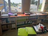 a desk with a lot of folders and a laptop on it