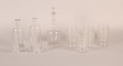 bottles and glasses are lined up on a white surface