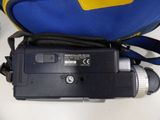 a camera sitting on top of a bag on a table