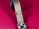 an image of a belt with a buckle on it on a pink background