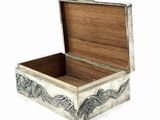 a small wooden box with a dragon design on it